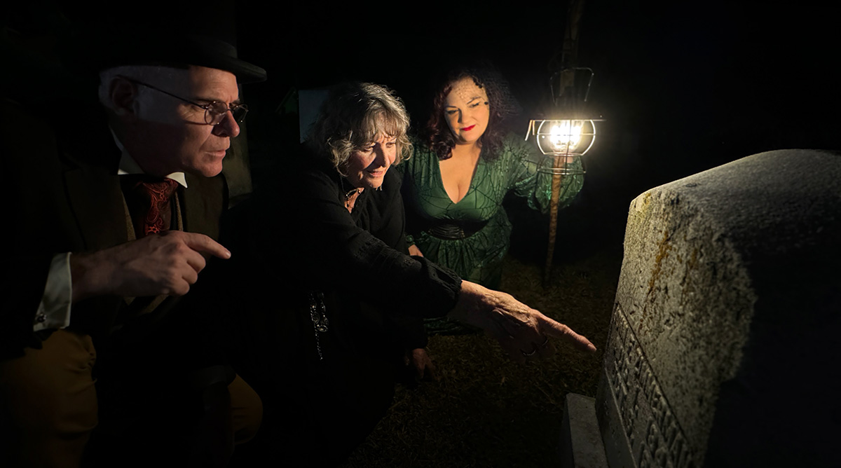 Families gather for a frightfully fun evening as a guide shares eerie tales on the Halloween ghost tour.